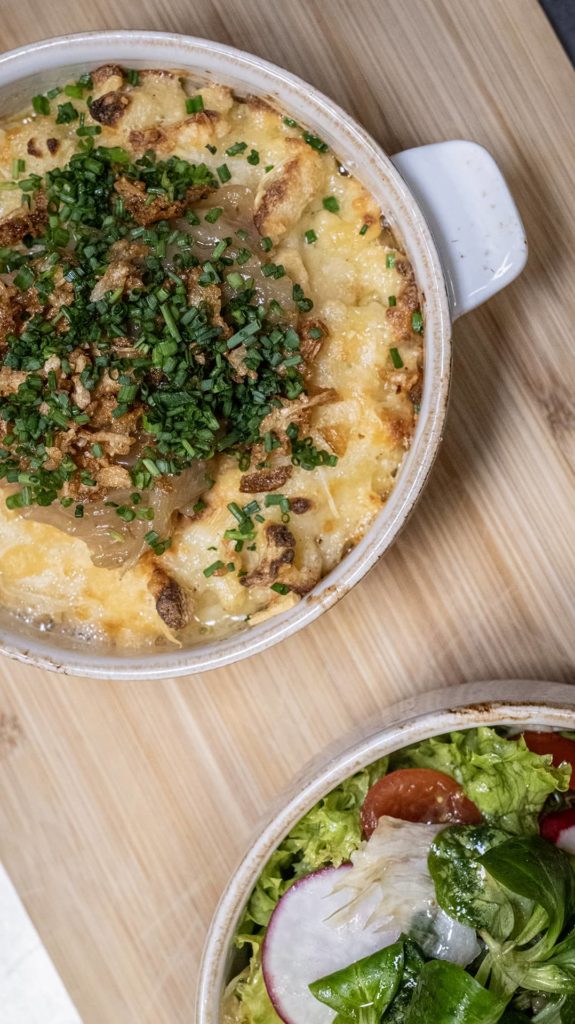 Spätzle mit Salat auf Holzbrett